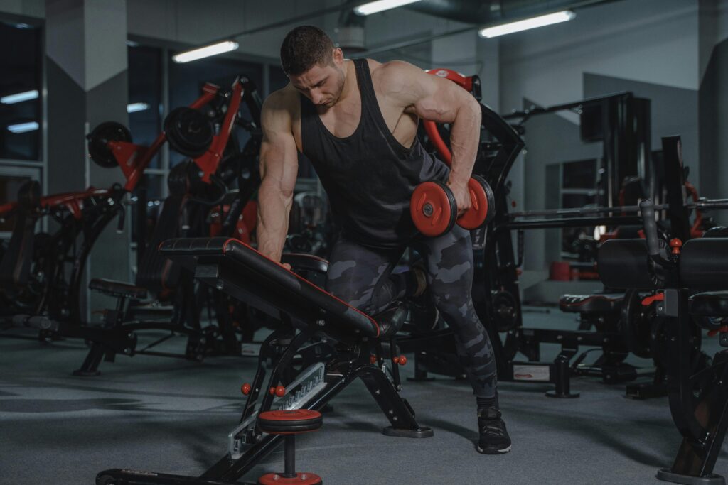 Strength Training to Building Muscle, Building Health: Take the Challenge to Change your Healthier Lifestyle 3 A strong muscled men doing Strength Training in a gym for building muscle and health