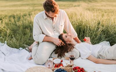 Couple enjoying healthy and happy life with superfoods in nature like a picnic