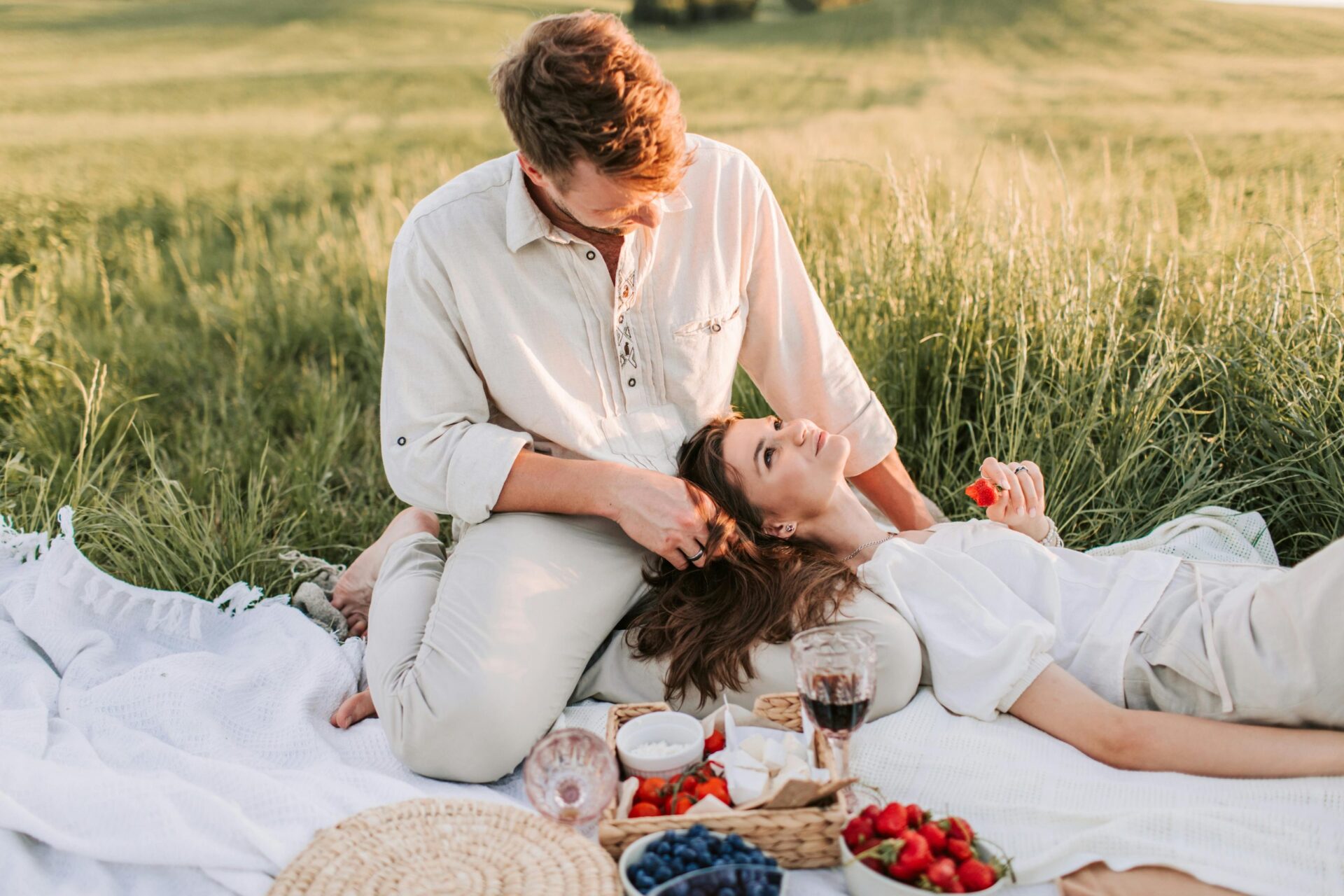 Couple enjoying healthy and happy life with superfoods in nature like a picnic